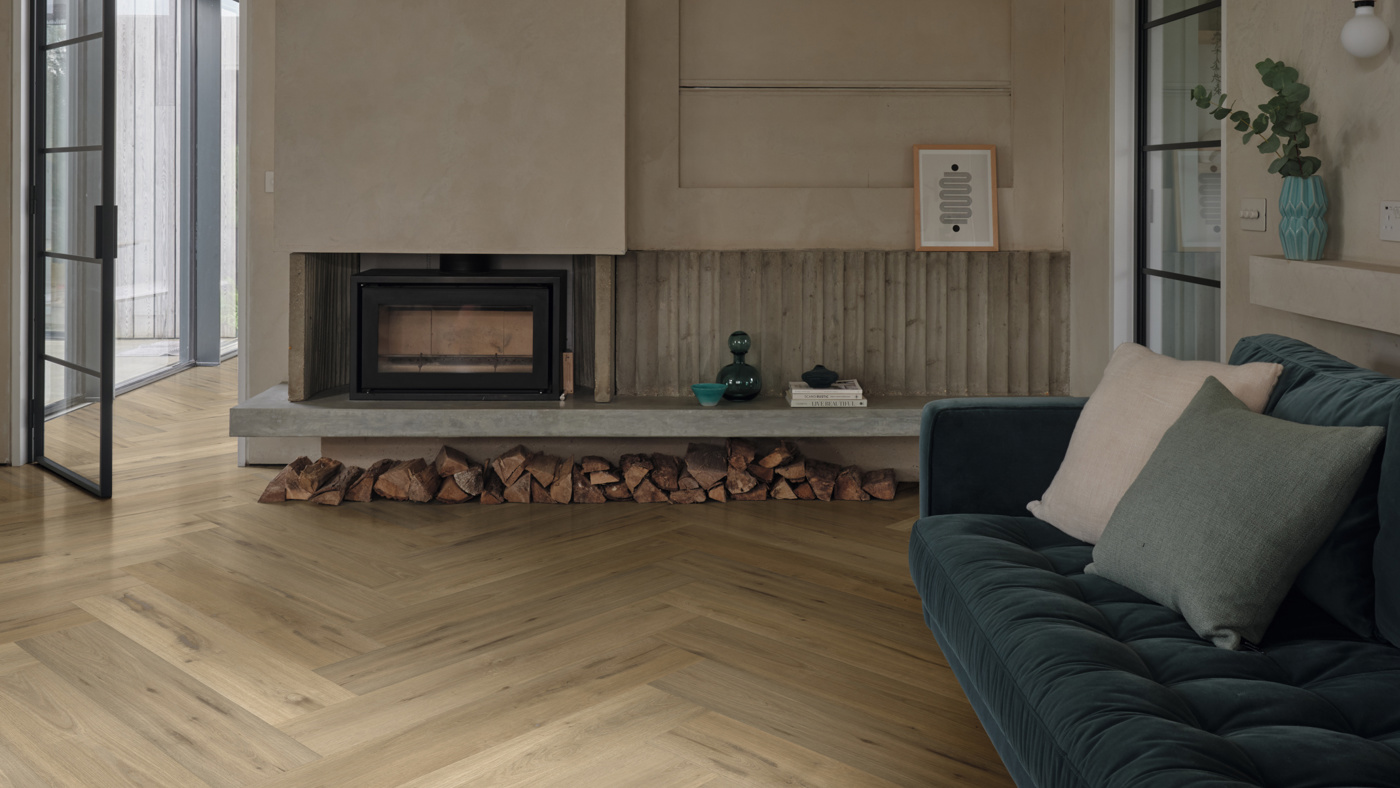 Leyster Oak lvp floors in a herringbone pattern direct the focus to the fireplace