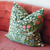 Floral print pillow on a pink sofa